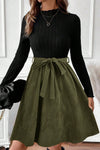 Chic Women's Black Ribbed Knit Dress with Slim Fit Bodice, Flared Skirt, and Trendy Belted Accent