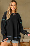 Cozy Women's Black Baggy Sweatshirt with Trendy Contrast Stitching and Chic Split Hem for Stylish Comfort