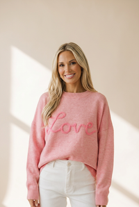 Cozy Women's Pink Baggy Graphic Sweater with Love Script - Effortless Casual Chic for Everyday Style made for easy styling and wardrobe coordination,