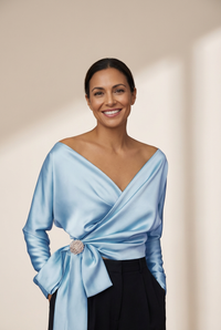 women's lustrous satin wrap blouse with brooch detail made for easy styling and wardrobe coordination, with premium-like structure and finish. with