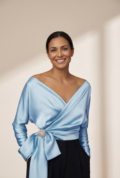 women's lustrous satin wrap blouse with brooch detail made for easy styling and wardrobe coordination, with premium-like structure and finish. with