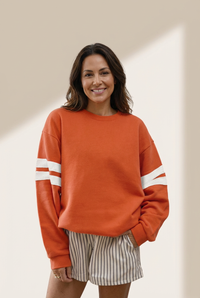Women's Sequin Turkey Varsity Striped Sweatshirt in Burnt Orange made for easy styling and wardrobe coordination, with premium-like structure and