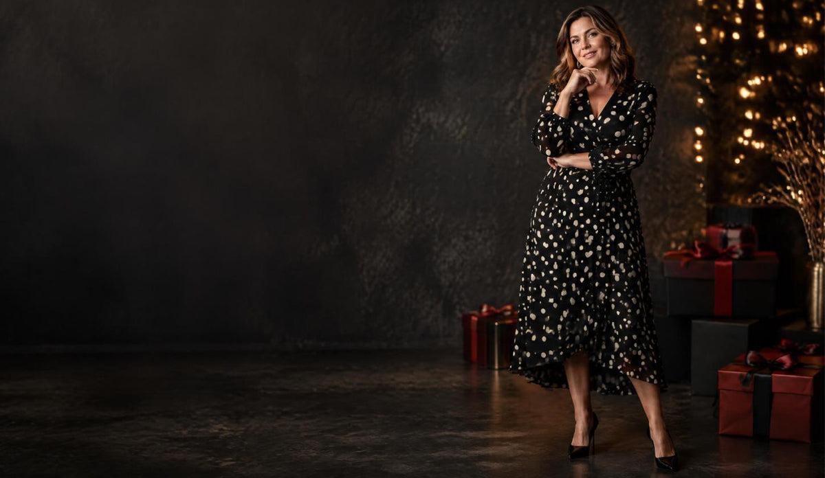 Woman in a black polka dot midi dress for the MsDressly Black Friday sale