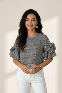women's black gingham ruffled bow blouse with half sleeves made for easy styling and wardrobe coordination, with premium-like structure and finish.