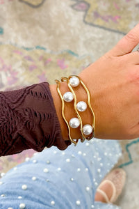 Gold Pearl Embellished Hollowed Waves Plated Bracelet