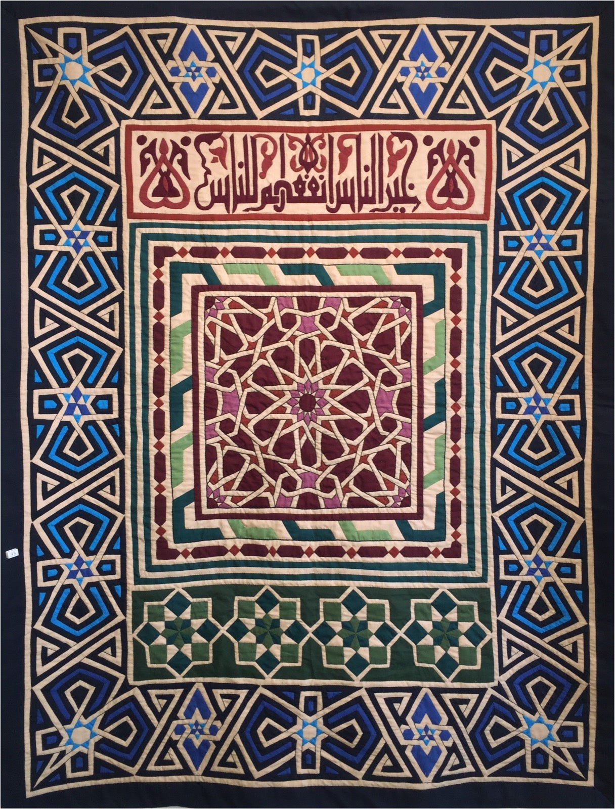 Egyptian appliqué textile with stitched fabric shapes on ground cloth.