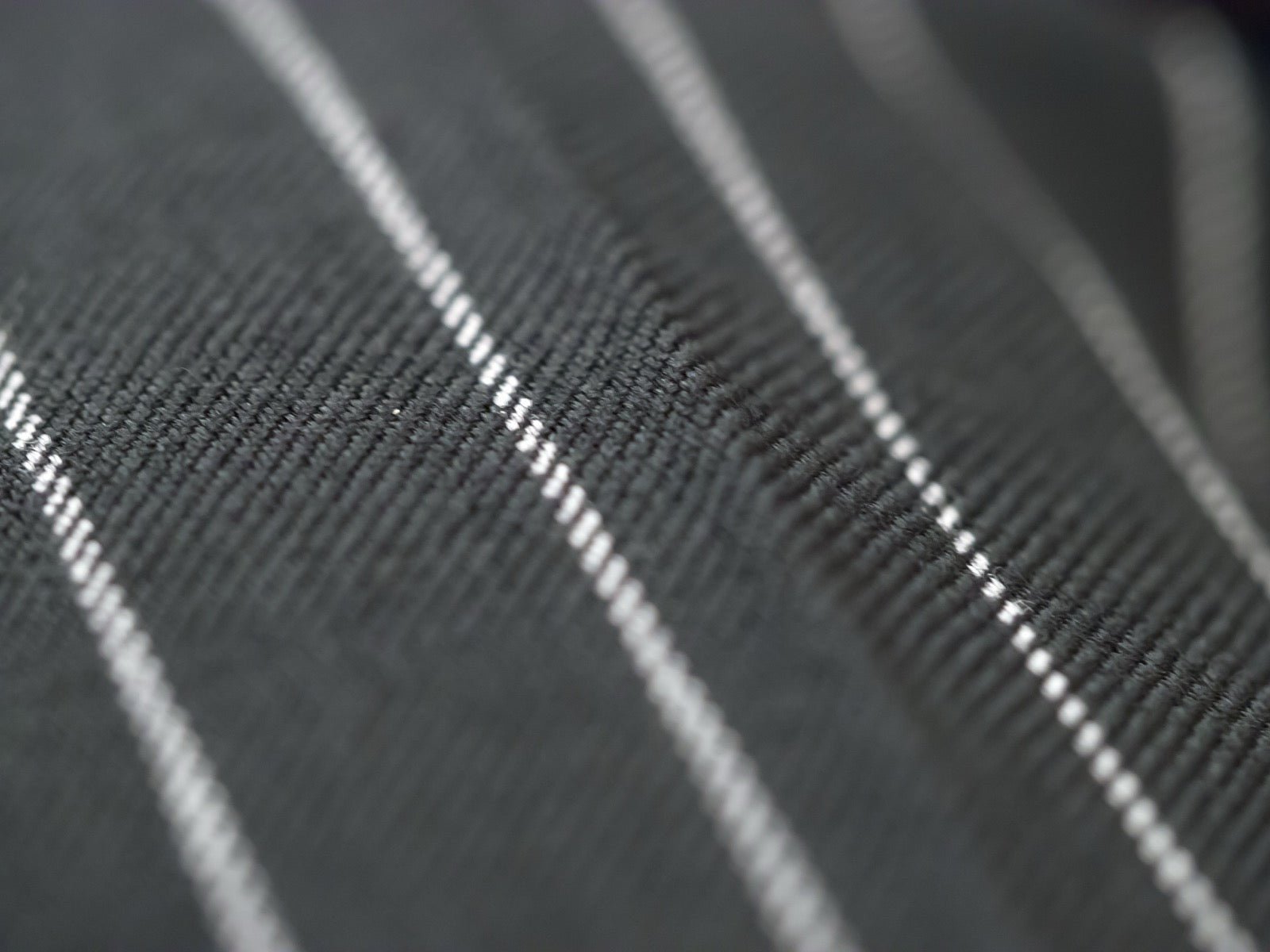 Wide chalk stripe suiting fabric with bold parallel lines.