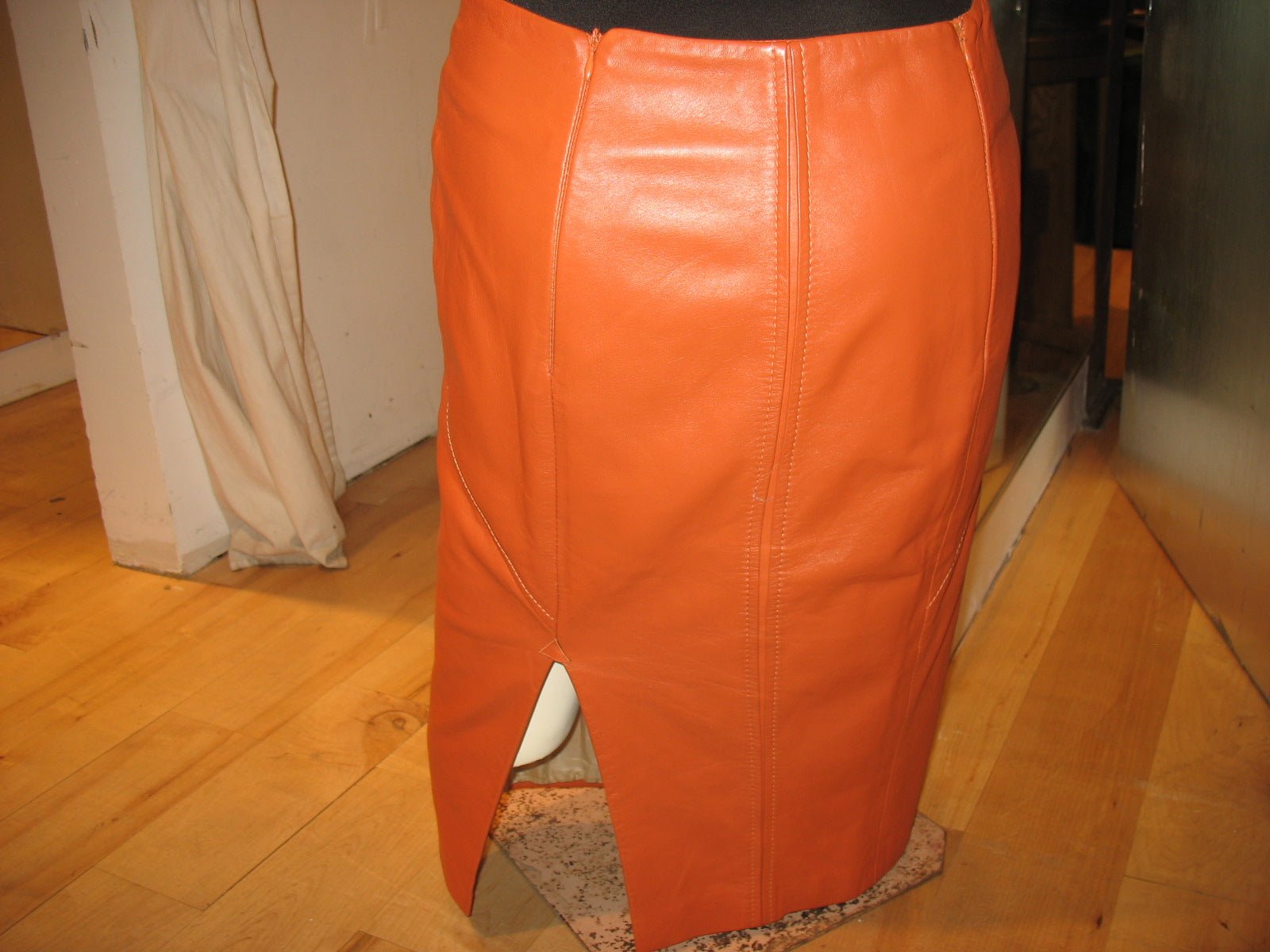 Leather skirt with back slit opening at hem panel.