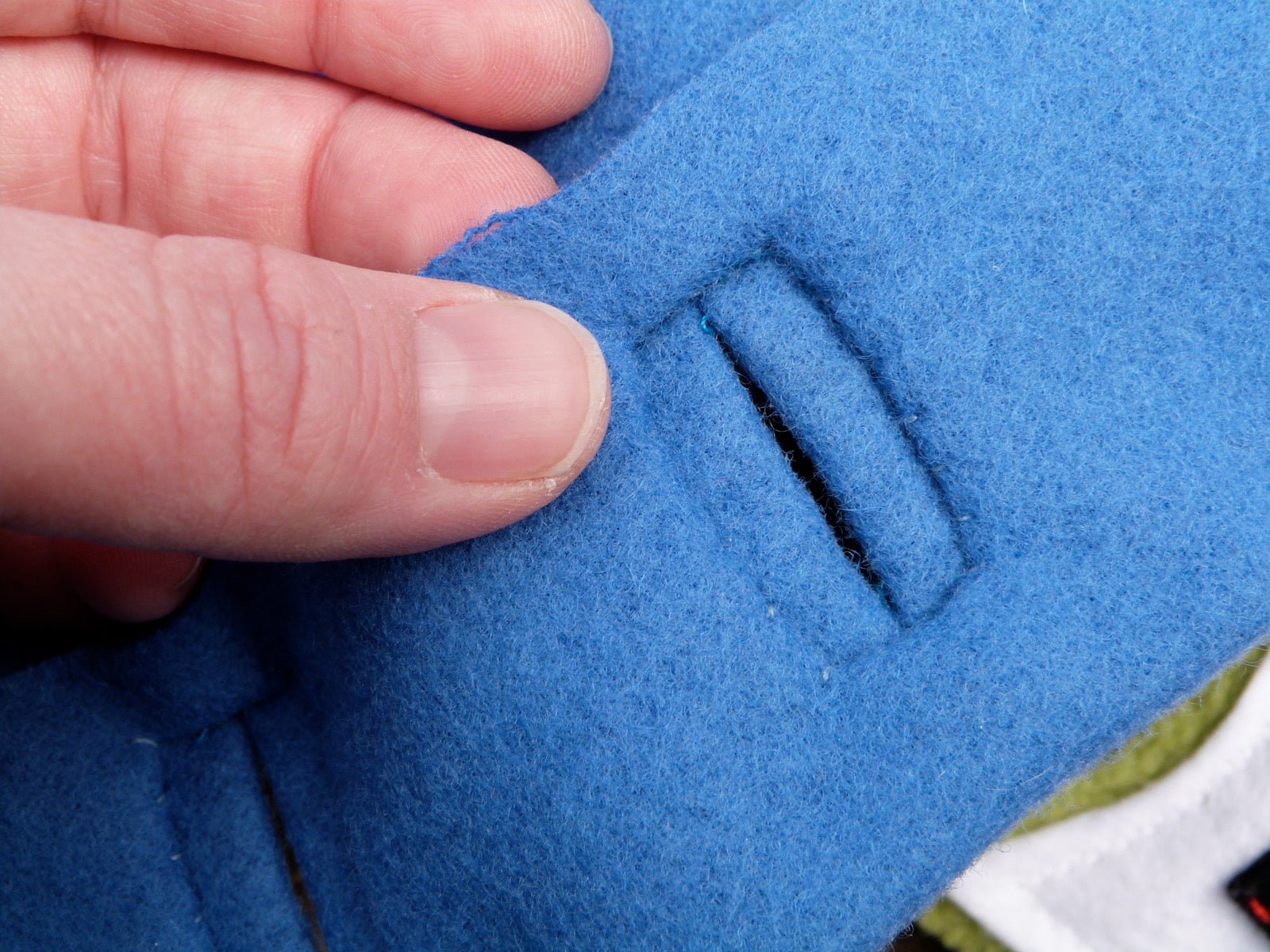 Bound buttonhole with fabric lip finish on tailored garment.
