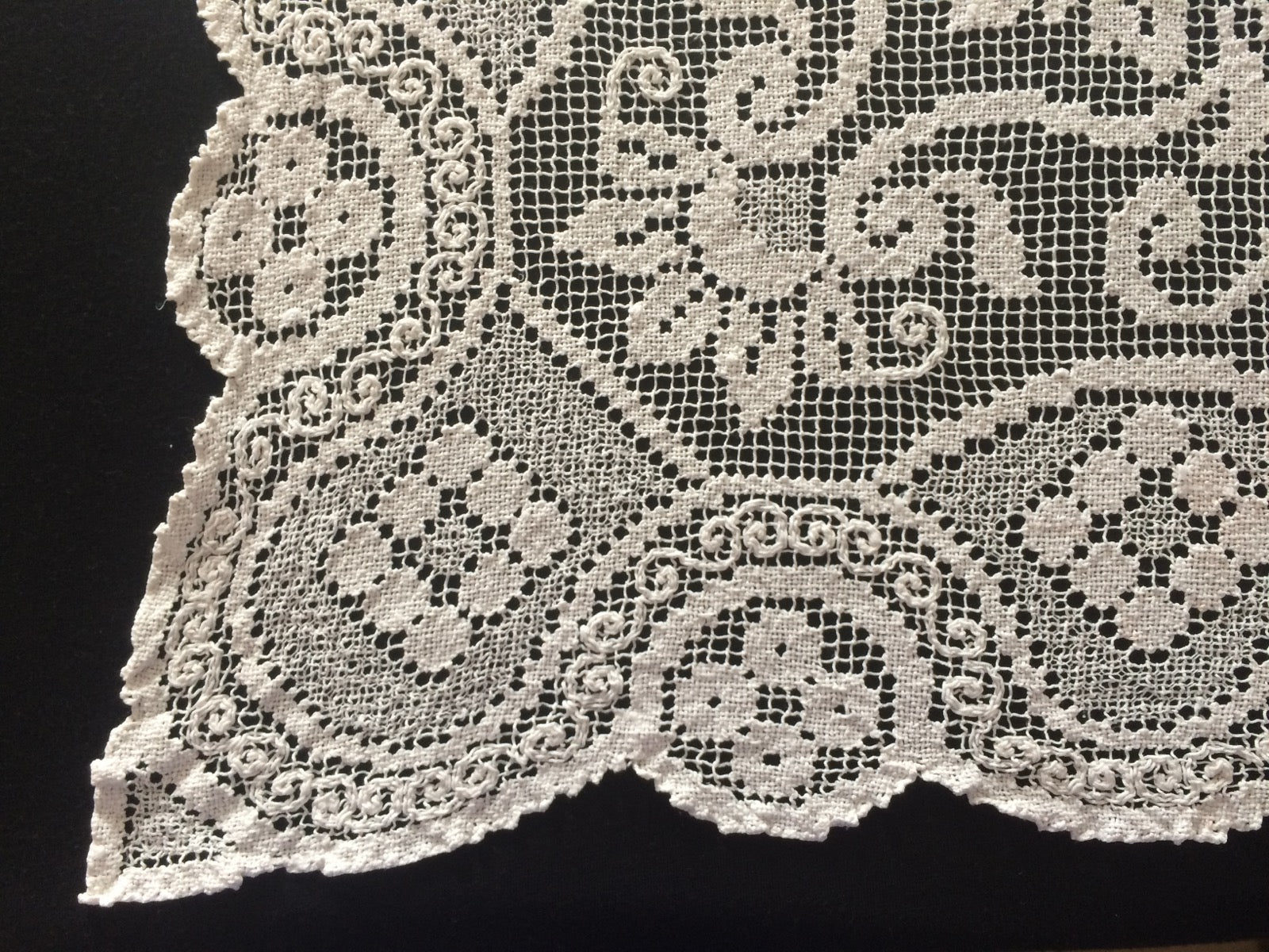 Norwegian filet lace with net ground and darned floral motifs.