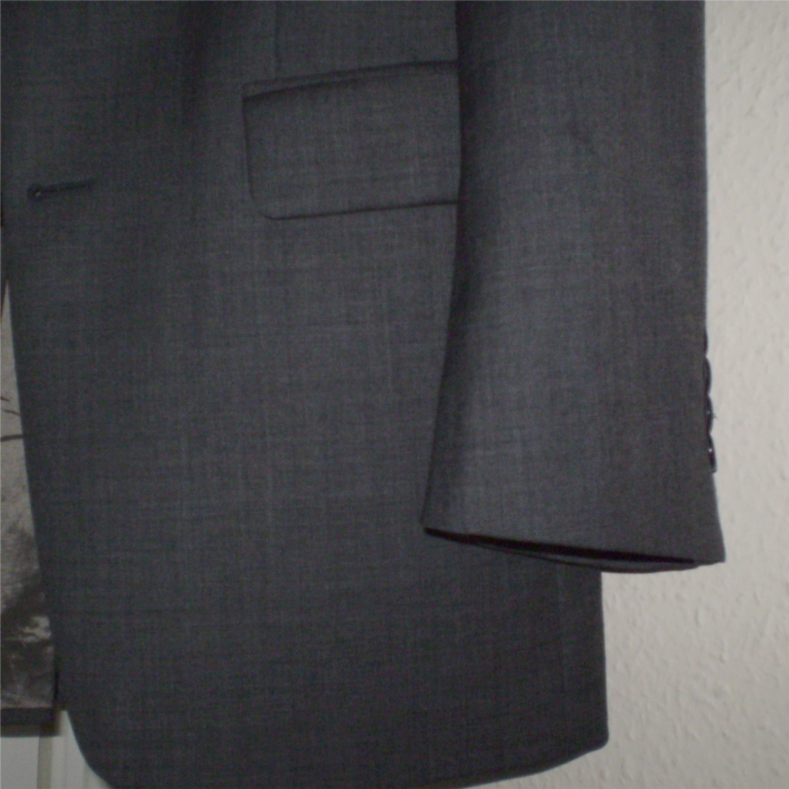 Jacket flap pocket with fold-over cover on outer panel.