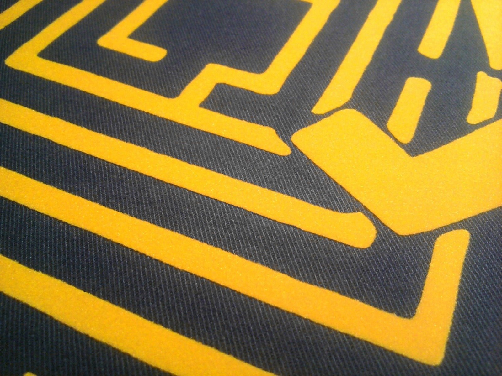 Golden-yellow flock foil sample on textile transfer film.