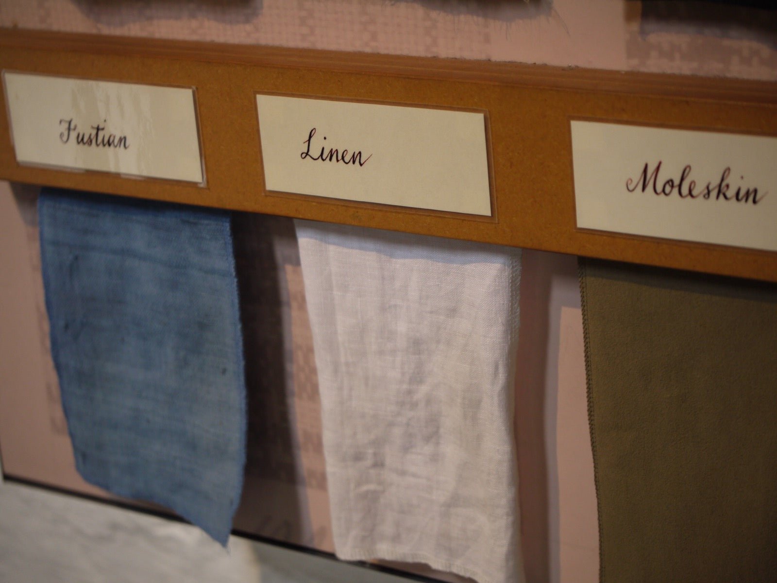 Historic textile samples labeled fustian, linen, and moleskin side by side.