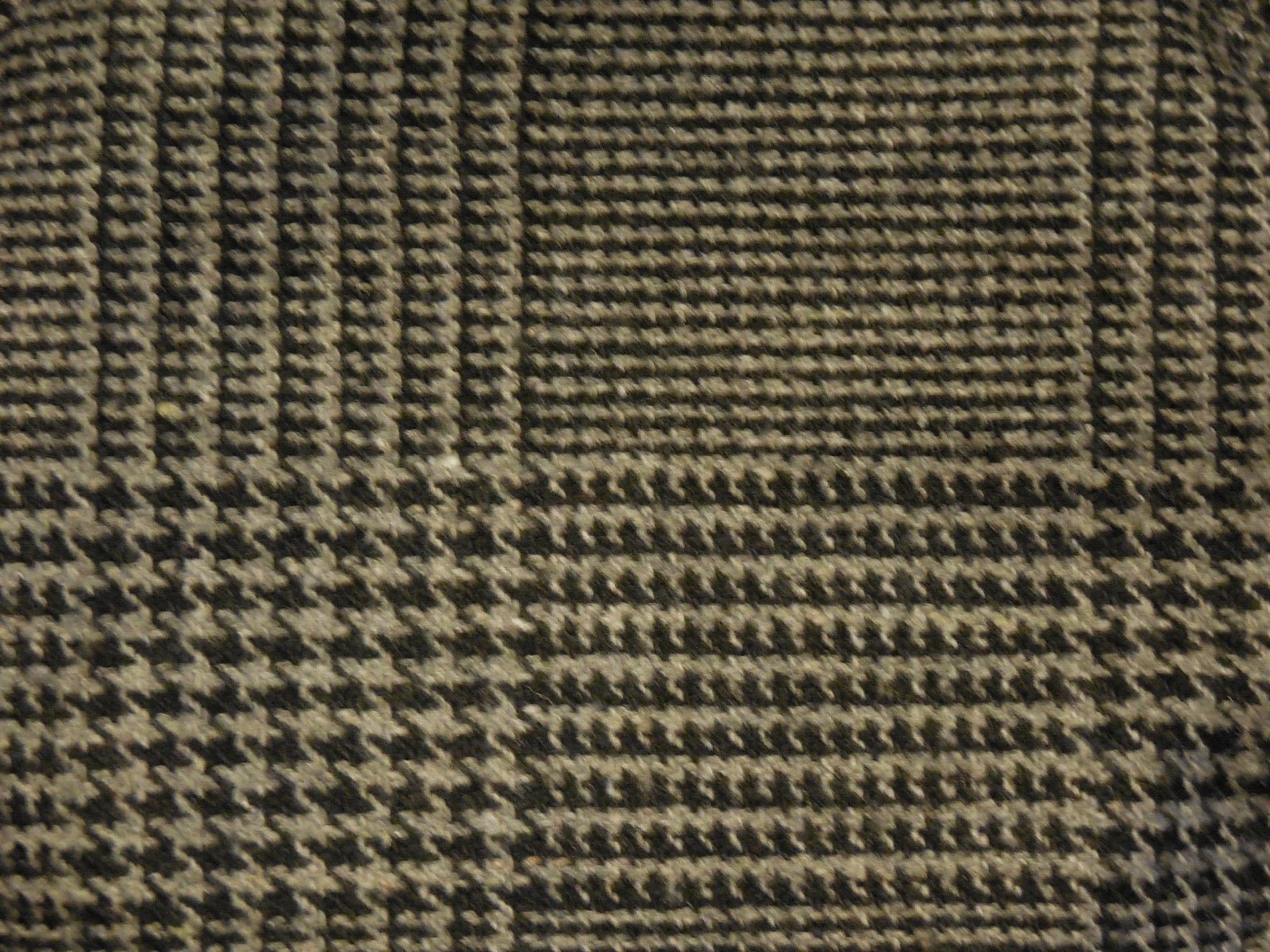 Glen plaid Prince of Wales check pattern in grey and black tones.