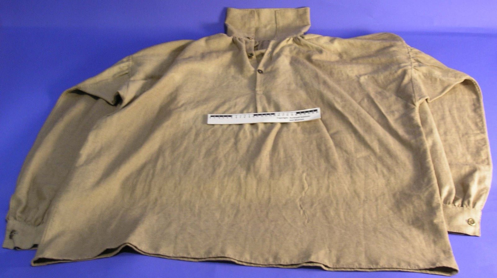 Shirt with underarm gusset panel for sleeve mobility.