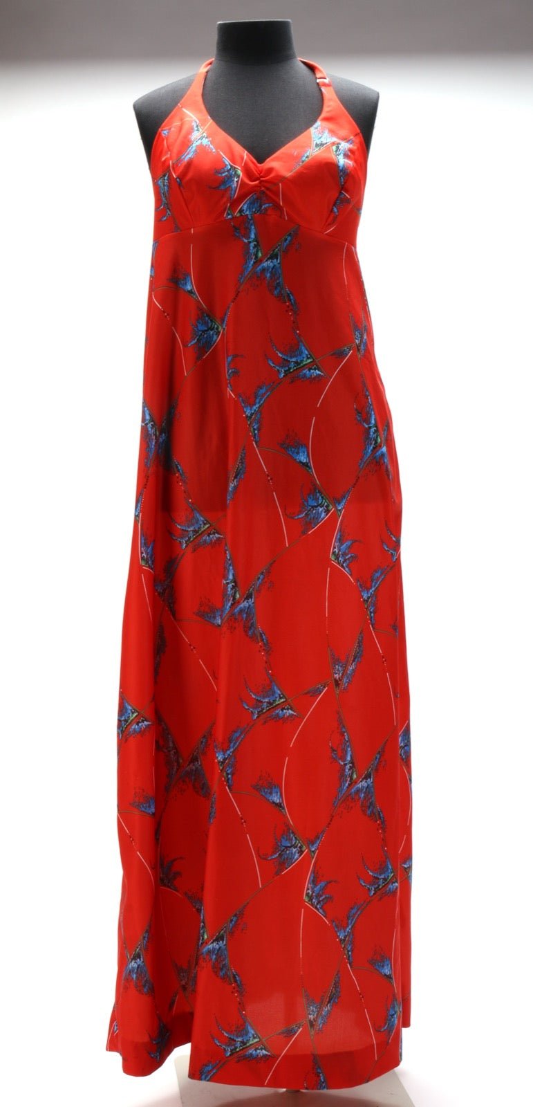 Halter-strap dress with neck-tie shoulder leaving arms bare.