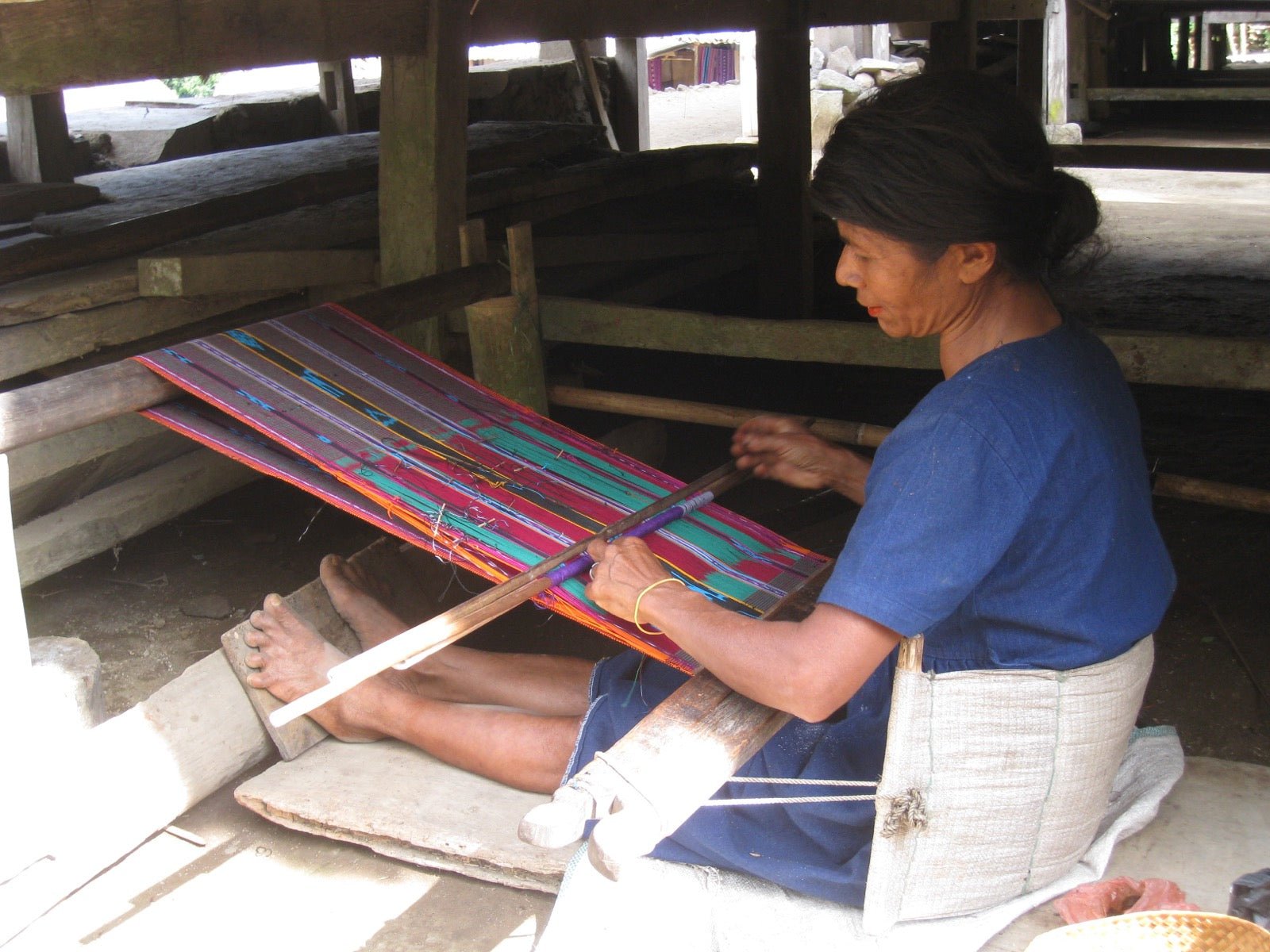 Ikat cloth with pre-dyed yarn blur at woven pattern edges.