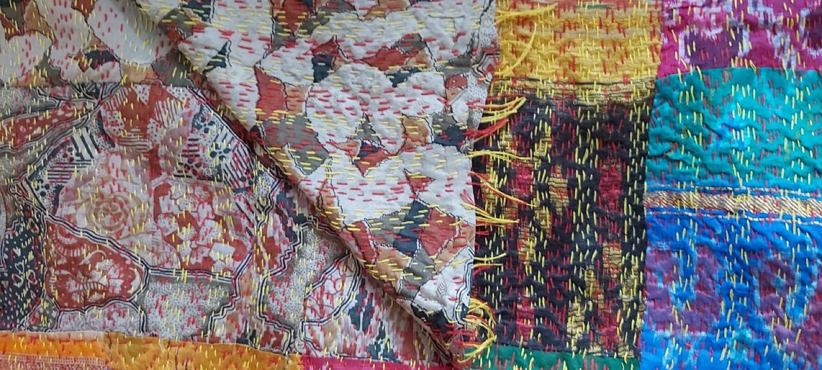 Kantha quilt running-stitch embroidery on layered recycled cotton sari cloth.