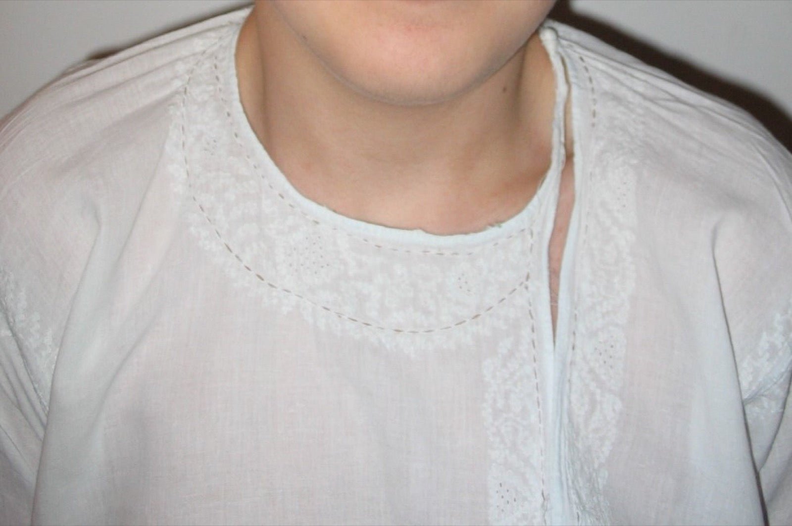 Kurta front placket with side-open knot closure on cotton tunic bodice.