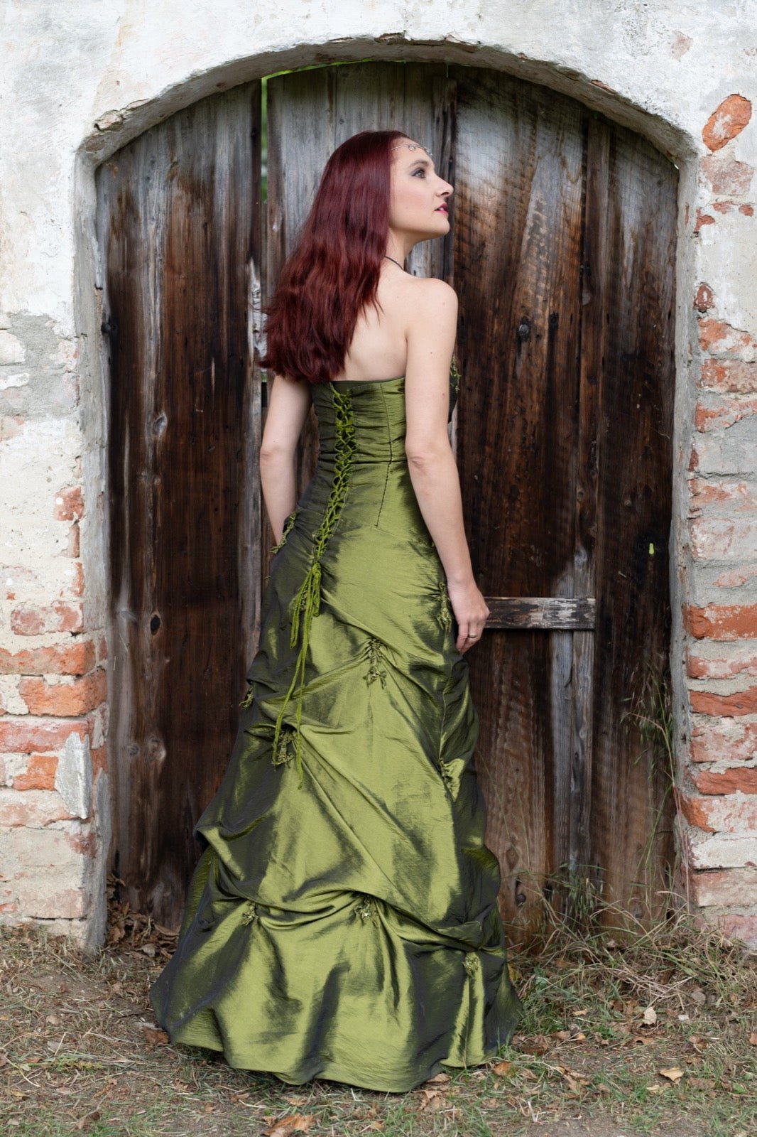 Evening dress rear view with lace-trimmed back panel and lacing.
