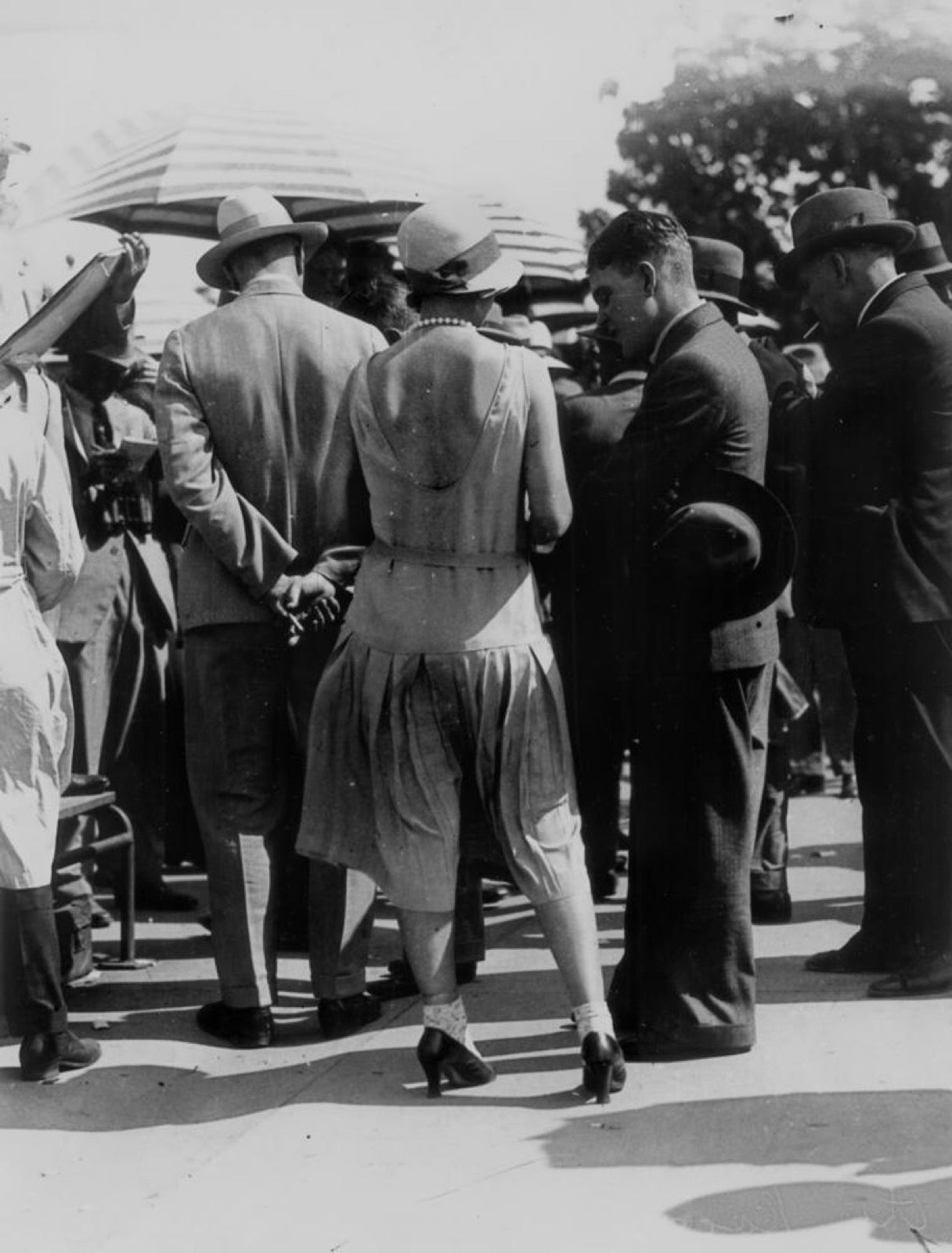 Low-backed dress exposing shoulder blades at rear bodice panel.
