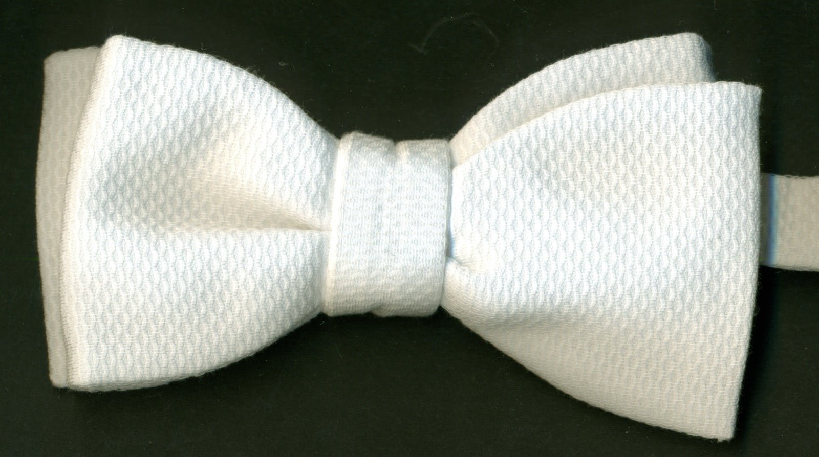 Close-up of piqué polo shirt fabric showing corded waffle texture.
