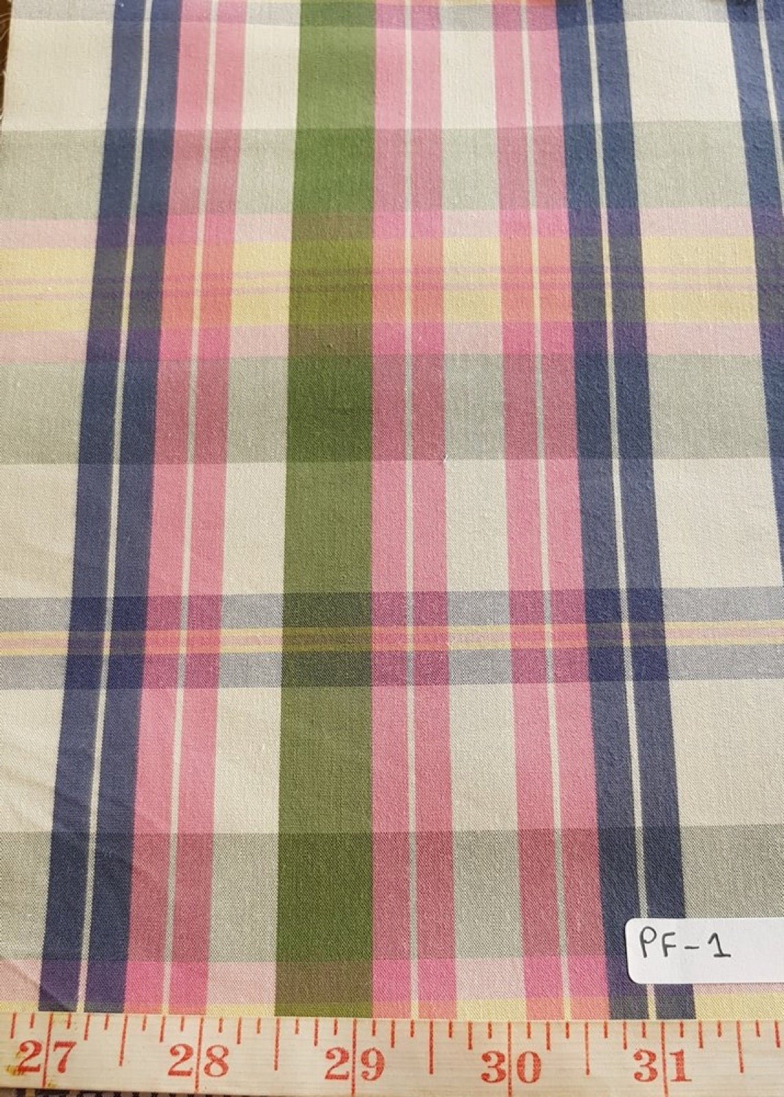 Madras plaid cotton fabric with crossed color bands.