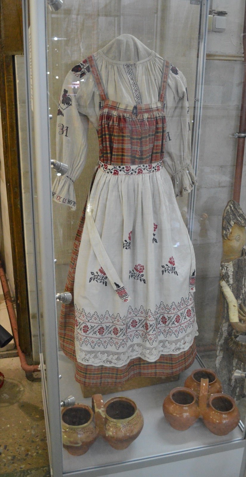 Sarafan silhouette jumper dress over blouse form.