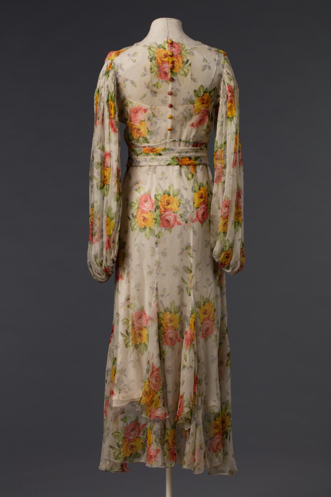 Evening dress with sheer back panel exposing foundation layer.