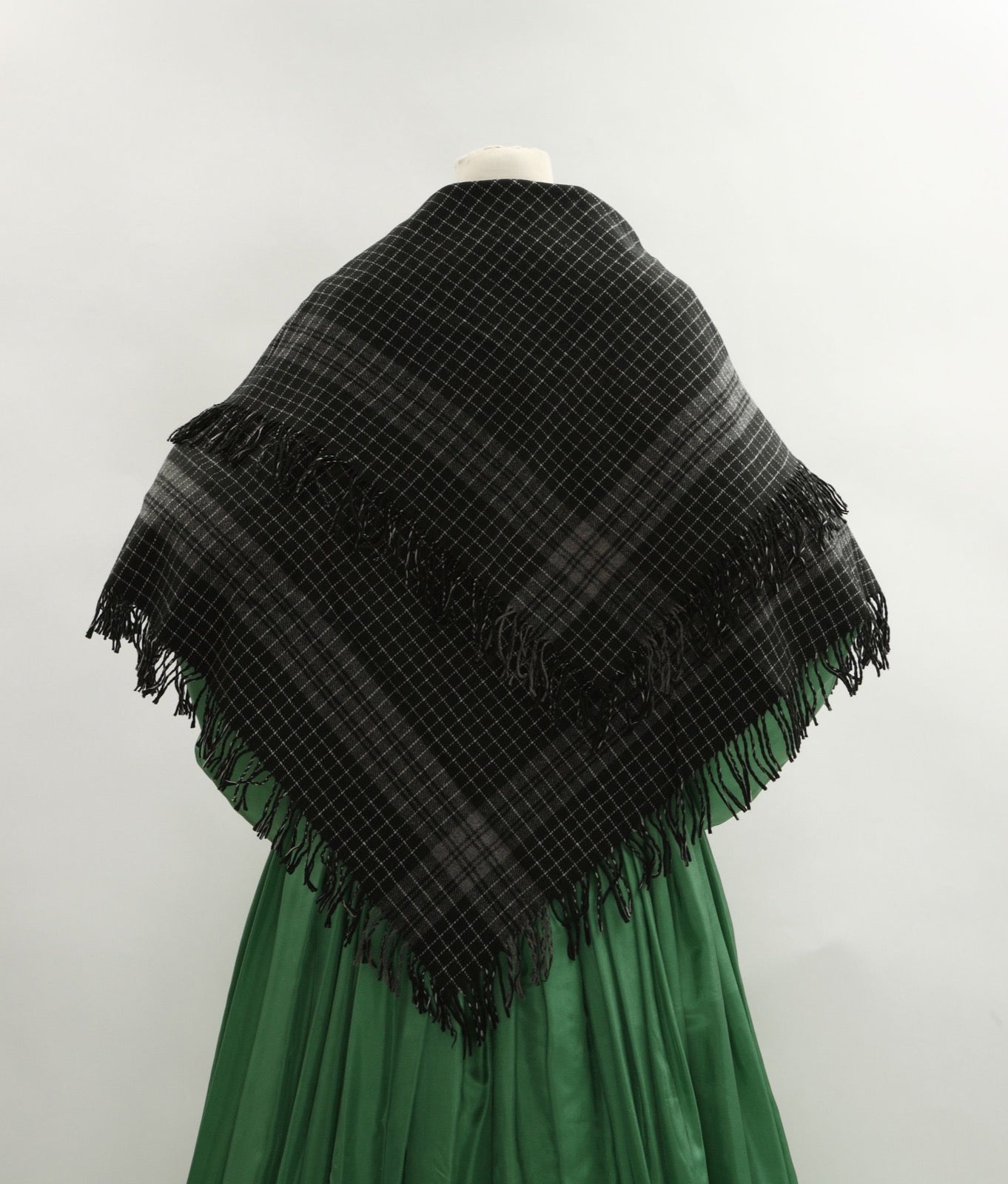 Black wool shawl with small white grid check pattern.
