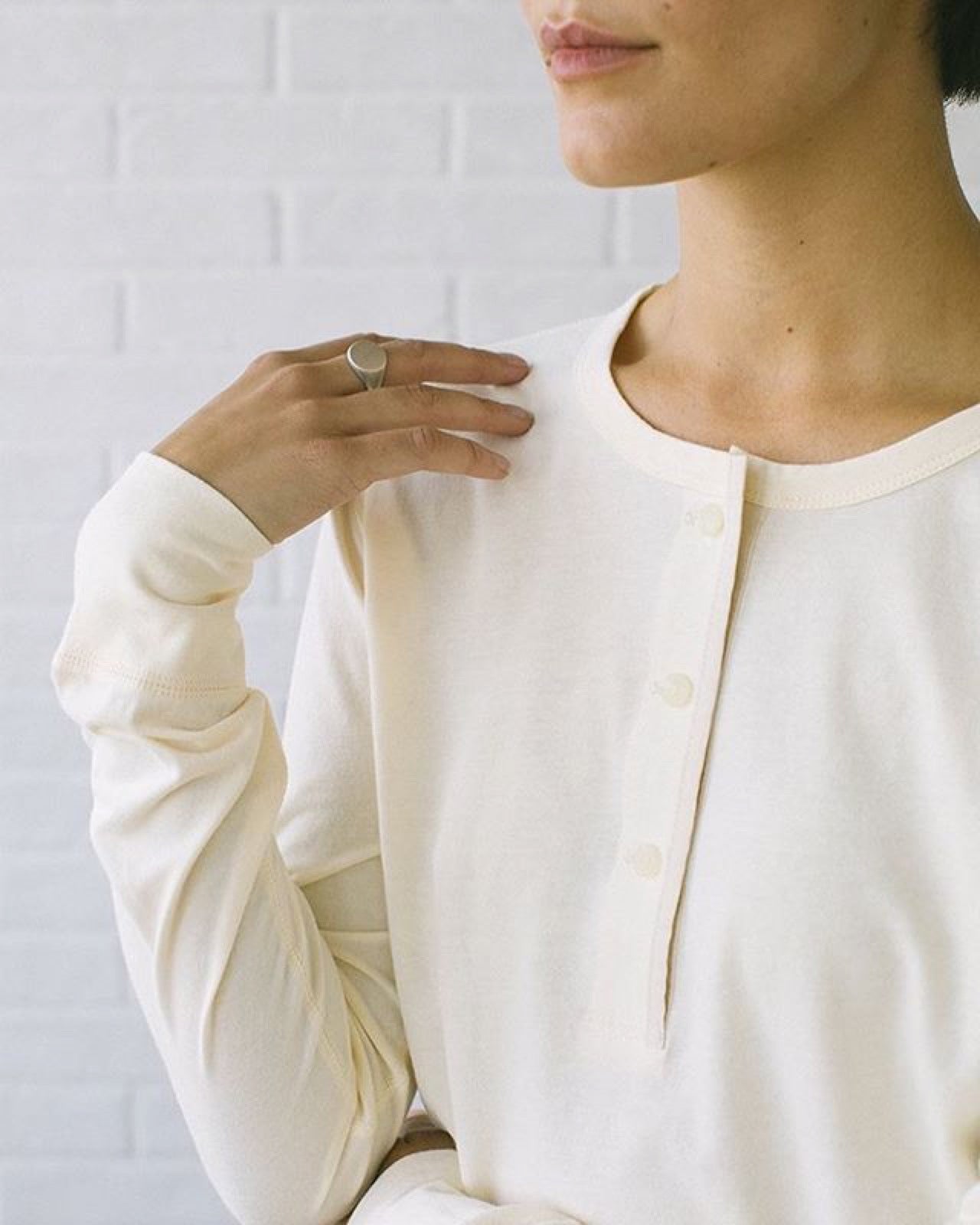 Henley shirt with split neckline and button placket at center front.