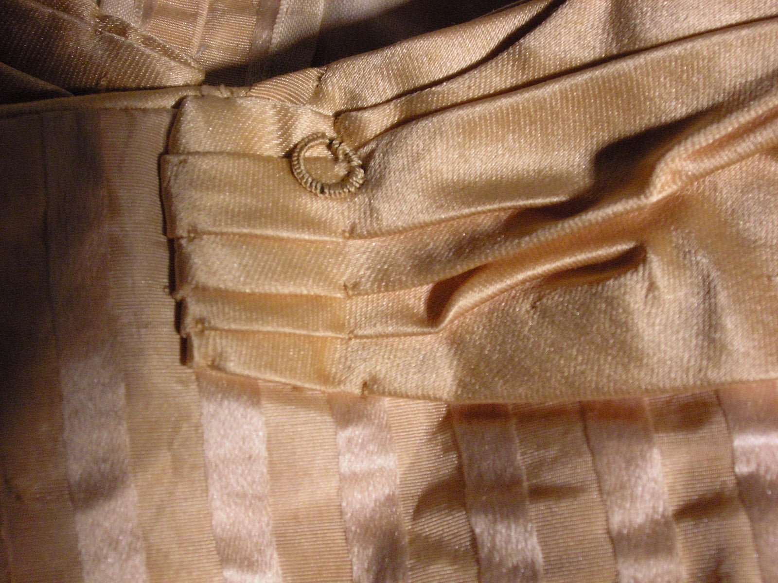 Woman's ensemble with horizontal square neckline across the chest.