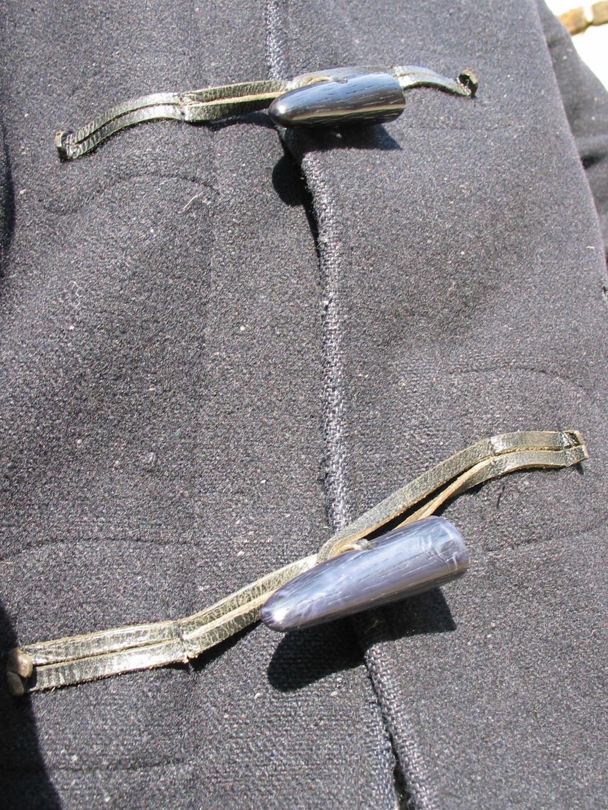 Toggle and cord fasteners on duffle coat front closure.