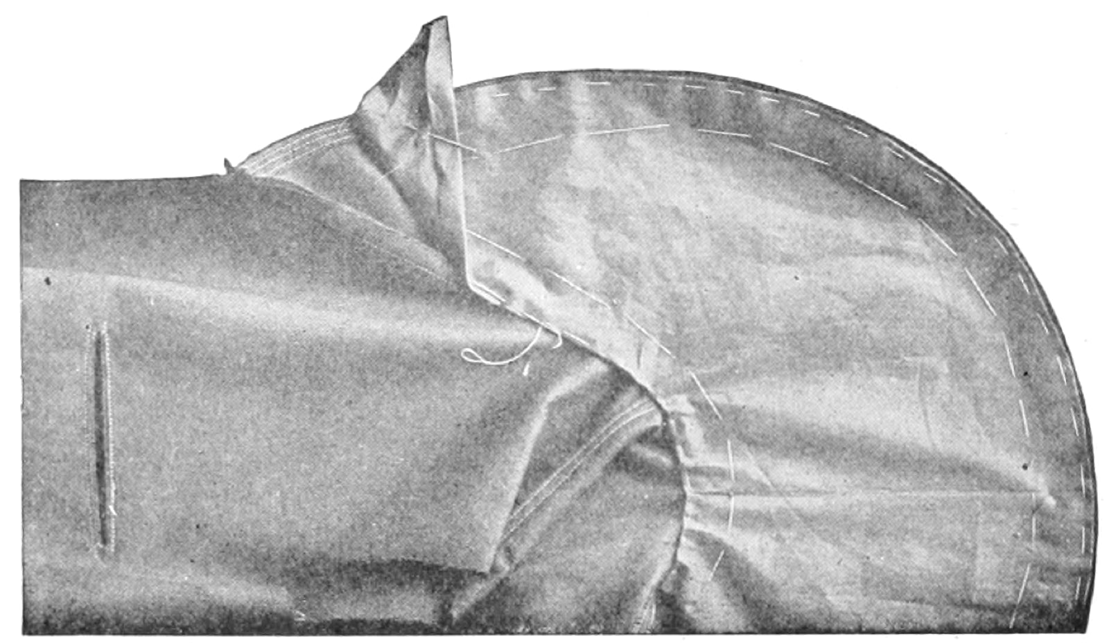 Top collar lining basted to collar on tailored construction.