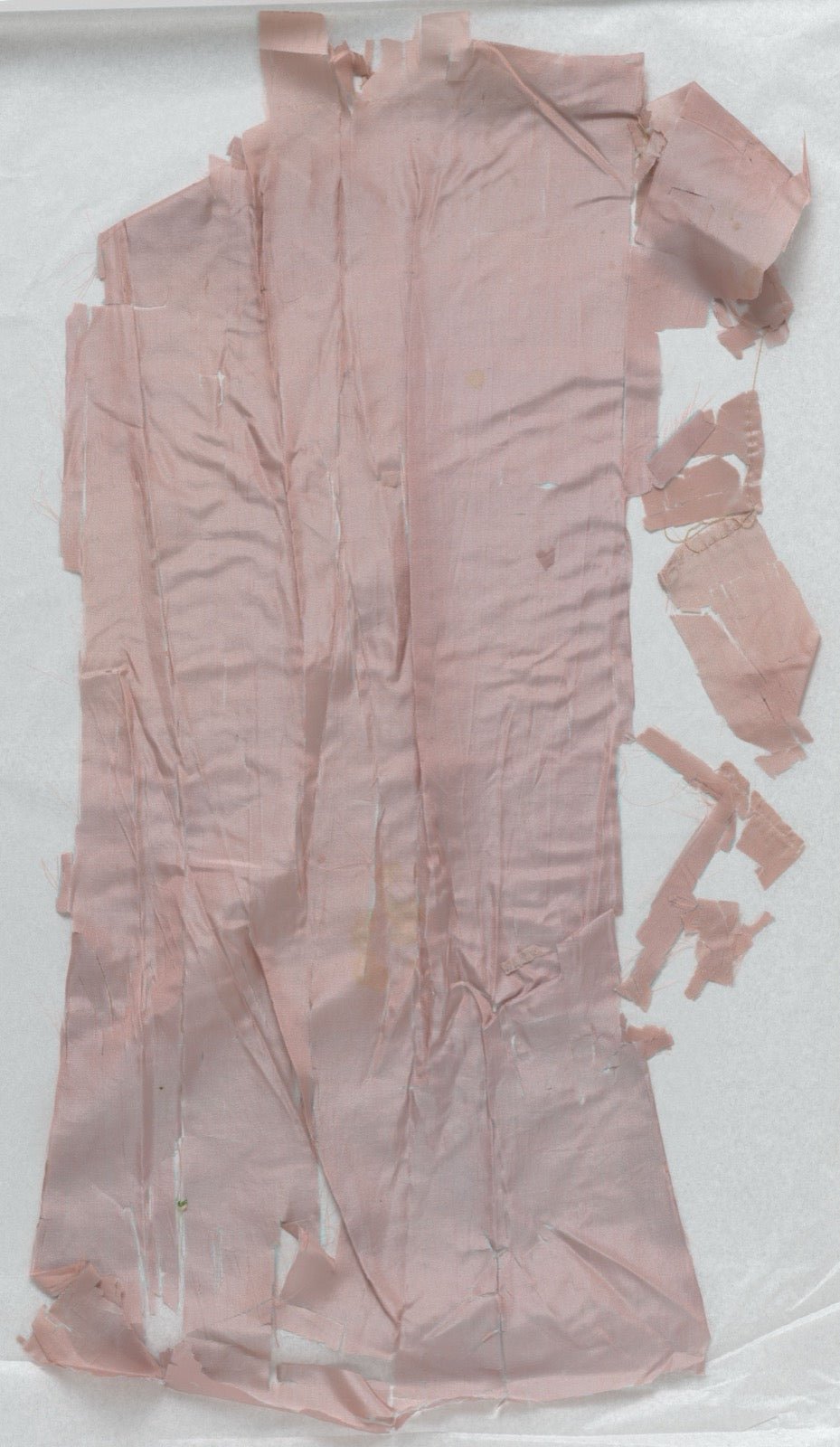 Changeant silk fragment in rose and blue showing iridescent color shift.