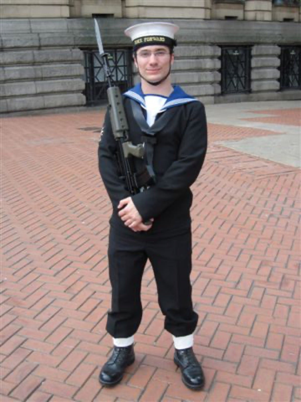 Naval uniform with standing collar band distinct from clerical tab collar.