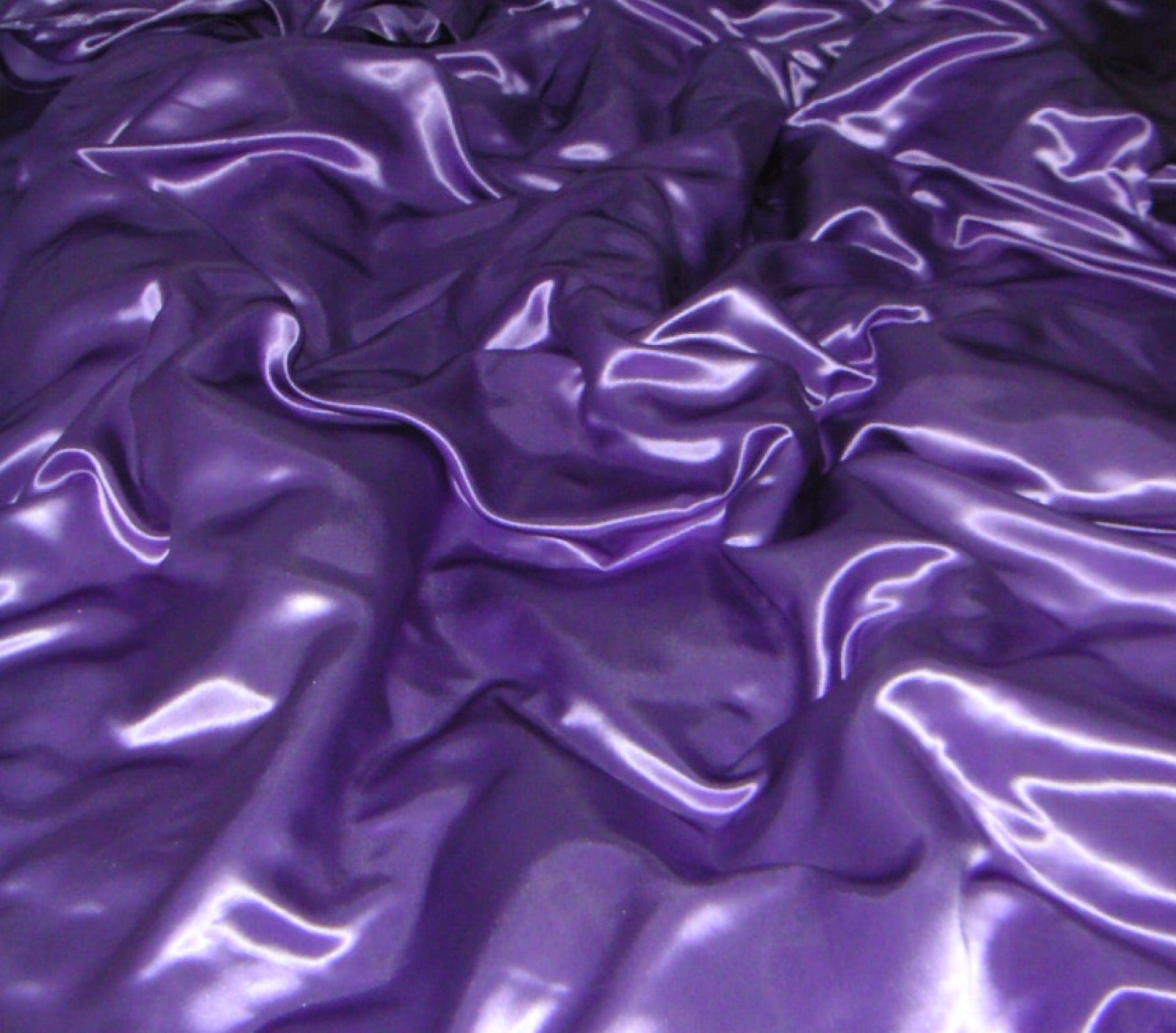 Smooth lustrous sateen bedding fabric with weft-faced sheen.
