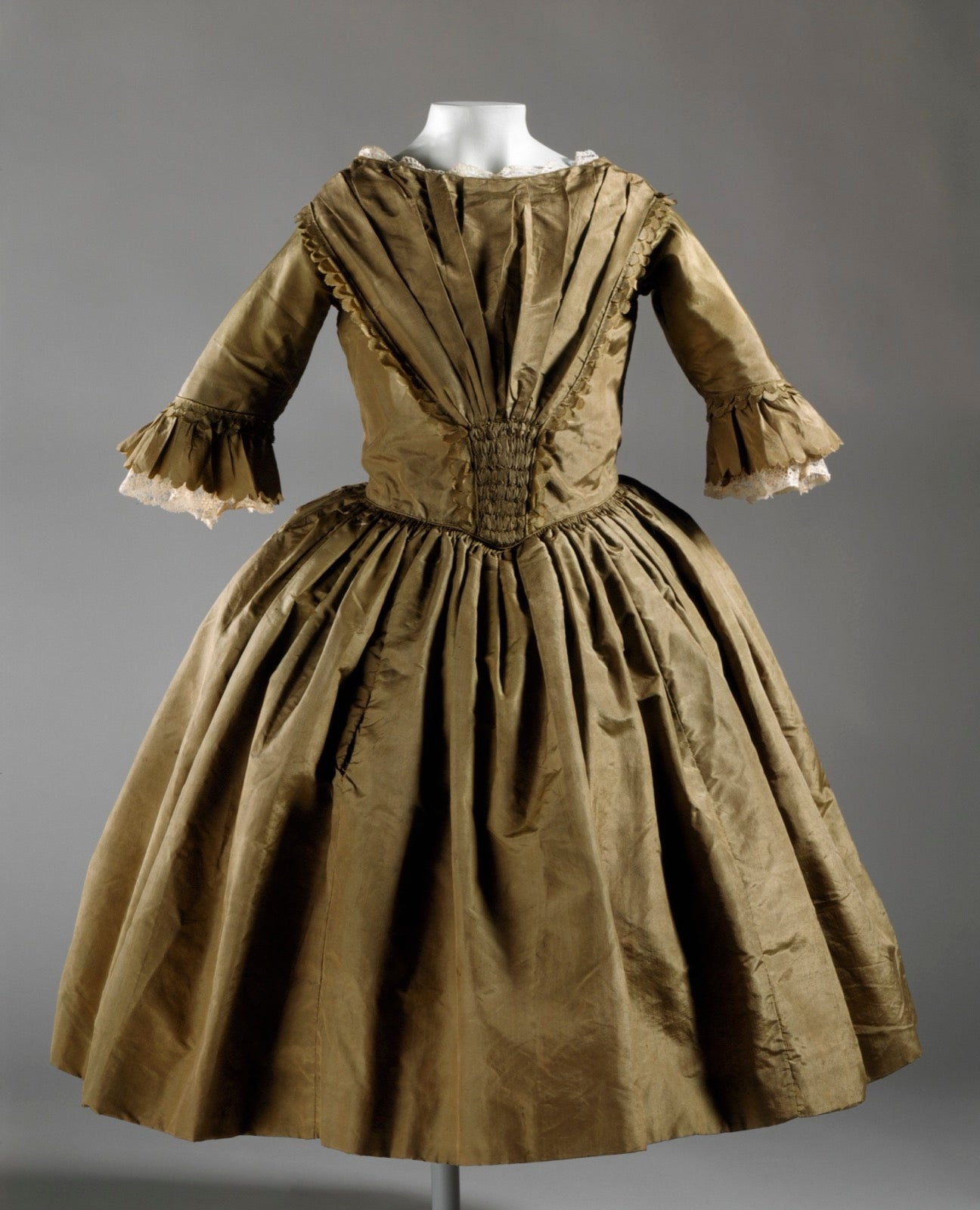 Girl's dress showing bodice and skirt panel zones on garment.